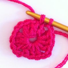 a crocheted object with a knitting needle