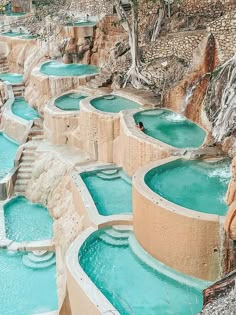 the water is blue and there are many pools in it that look like they have been built into the ground