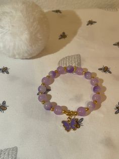 Cute purple bracelet with butterfly charm Adjustable Butterfly Charm Bracelet, Handmade Casual Purple Bracelets, Lavender Casual Jewelry For Gifts, Casual Purple Handmade Bracelets, Casual Handmade Purple Bracelets, Casual Handmade Lavender Jewelry, Adjustable Charm Bracelet With Butterfly Charm As Gift, Casual Butterfly Charm Jewelry As Gift, Casual Butterfly Charm Jewelry For Gift