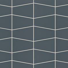 a gray and white tiled wall with lines on the bottom, in an angled pattern