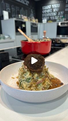 a white bowl filled with food on top of a counter