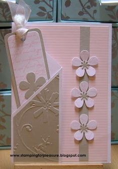 two cards with flowers on them and one has a tag attached to the back of it