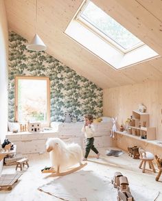 a room with wooden floors and walls covered in wallpaper