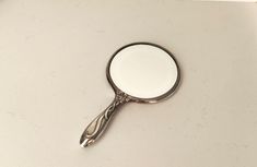 a magnifying glass sitting on top of a white counter next to a sink