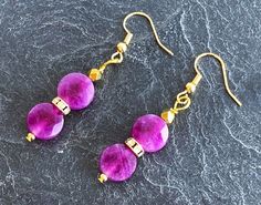 Sugilite earrings: two flat round faceted beads 10-10.5mmx5-6 mm, one 18K gold-plated rhinestone rondelle, one 18K gold-plated faceted bead 4 x 3.5 mm; with 18K gold-plated brass the sugilite is naturally uncolored Sugilite earrings / jewelry / Sugilite earrings / yoga / Sugilite beads / delicate beads / real Sugilite jewelry / purple violet / purple Sugilite earrings / purple violet earrings / purple Sugilite beads / purple earrings / purple jewelry Gold Earrings With Gemstone Beads, Purple Gemstone Round Bead Earrings, Purple Gemstone Earrings With Round Beads, Violet Earrings, Sugilite Jewelry, Jewelry Purple, Purple Jewelry, Earrings Purple, Purple Earrings