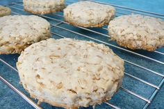 several cookies cooling on a wire rack with blue tablecloth and blue cloth in the background