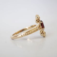 The Peonies Oval Diamond is made out of sculpted peonies and petals. A bouquet of beautiful peonies to wear on your finger to remind you of the beauty of life. Featuring a natural maroon red garnet. Handcrafted in 14K and 18K solid gold in our NYC studio. 14K or 18K solid gold Natural oval 6*4mm garnet Natural round diamonds on the side 1.5mm ring band ** This item is specially made for you. Please allow 1-2 week lead time. Shipping:Domestic: Free shippingInternational: Free shippingAll orders a Luxury Gold Cluster Ring With Accent Stones, Luxury Gold Ruby Ring With Halo Design, Garnet And Pearl Ring, Oval Garnet Rings, Unique Oval Garnet Rings, Oval Garnet Jewelry With Intricate Design, Ornate Oval Garnet Ring, Oval Diamond Ring, Elegant Ring