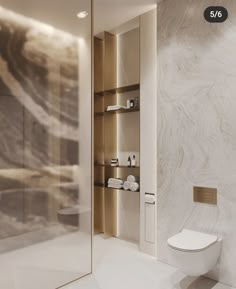 a white toilet sitting next to a glass door in a bathroom with marble walls and floor