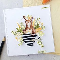 a card with an image of a dog in a coffee cup and carrots next to it