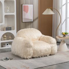 a white chair sitting on top of a rug in a living room next to a lamp