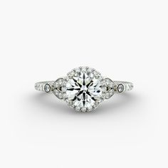 a white gold engagement ring with an oval center stone surrounded by round brilliant cut diamonds