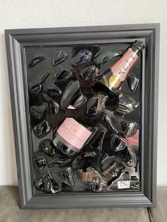 a framed photo with wine bottles and glasses in it