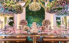 an elaborately decorated dining room with flowers and chandelier