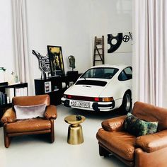 a living room filled with furniture and a white car