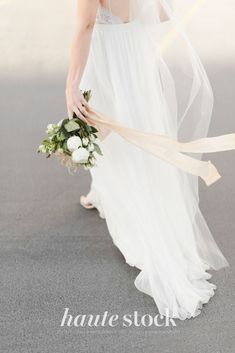 a woman in a wedding dress holding a bouquet