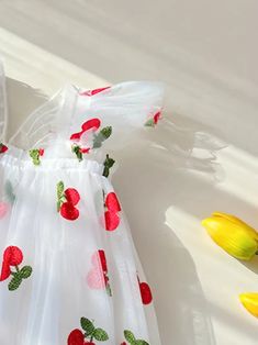 Frolic through the day in this delightful cherry-embellished flower girl dress. The airy tulle skirt is sprinkled with a cheerful pattern of red fruit and greenery, invoking the playful spirit of a sunny orchard. With its flutter sleeves and an oversized back bow, this dress is perfect for a little one who loves to play dress-up for real-life special occasions. US Length Bust size 9-12M 18.5 20.1 1-2Y 19.3 20.9 3-4Y 20.5 22.1 4-5Y 21.7 23.2 5-6Y 22.9 24.0 Whimsical Summer Dress With Tulle Skirt, Whimsical Summer Tulle Dress, Cute Spring Tulle Skirt Dress, Spring Floral Applique Princess Dress For Garden Party, Cute Tulle Princess Dress For Garden Party, Cute White Princess Dress For Garden Party, Whimsical Tulle Princess Dress For Spring, Whimsical Spring Tulle Princess Dress, Flower Shaped Summer Princess Dress For Party