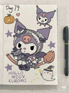 a notebook with an image of a witch and her cat on it next to a pen