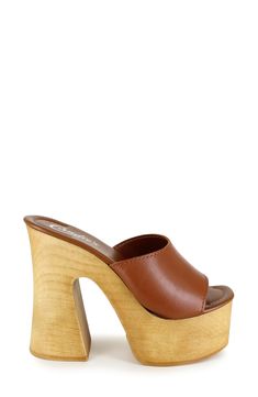 A woodgrain platform and soaring block heel lend scene-stealing height and retro-cool appeal to a slide sandal that will elevate your trendsetting looks. 4" heel; 2" platform Leather upper and lining/synthetic sole Made in Spain Spring Clogs With 4-inch Wedge Heel, Trendy Wedge Heels With Wooden Heel, Summer Retro Brown Mules, Trendy Wooden Wedge Heels, Trendy Wedge Sandals With Wooden Block Heel, Brown High Heel Clogs With Sculpted Heel, Modern Brown Heels With Wooden Heel, Brown Clogs With Sculpted Heel For Spring, Spring Platform Slippers With Wooden High Heel