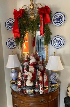 a christmas scene with santa clause decorations and blue and white plates on the wall behind it