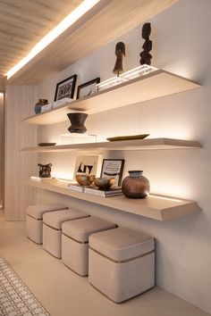 the shelves are filled with vases, bowls and other decorative items on display in this modern style living room