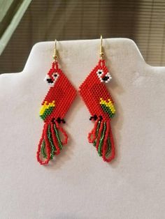 red bird beaded earrings hanging from gold hooks