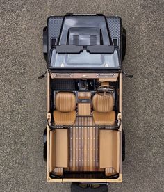 an overhead view of the inside of a vehicle with its seats folded down and luggage in the back