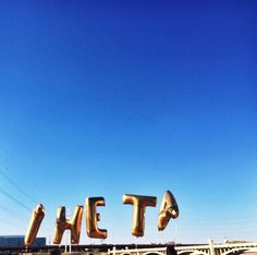 a large sign that says the city in front of a bridge