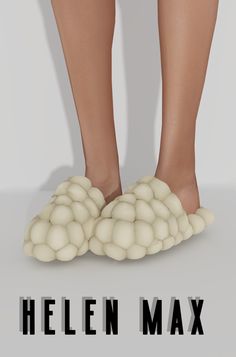 the legs and feet of a person standing on white balls in front of a gray background