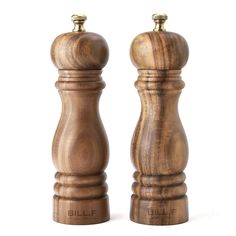 two wooden salt and pepper shakers sitting next to each other