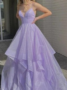 a woman in a purple dress posing for the camera