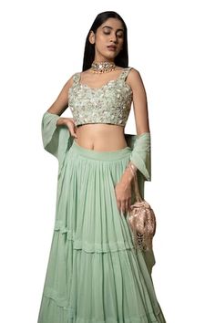 Green attached cancan pleated lehenga. Paired with a floral zardosi, pearl, bead and zari embroidered padded blouse and dupatta. - Aza Fashions Designer Fitted Anarkali Set With Ruffles, Ruffled Sets For Reception, Navratri Festival, Ruffled Sets For Reception And Navratri, Ruffled Sets For Reception During Navratri, Fitted Anarkali Set With Ruffles For Diwali, Fitted Ruffles Anarkali Set For Festivals, Fitted Ruffle Sets For Reception, Ruffled Lehenga For Wedding And Festivals, Wedding Lehenga With Ruffles For Festivals