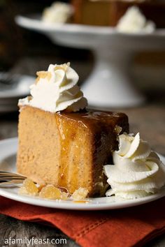 a slice of cake on a plate with whipped cream