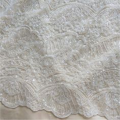 "This stunning Lace Fabric design piece has soft hand feel, It's perfect for weddings, bridal parties, and any events. Shop our large inventory of bridal fabrics. ☆PRODUCT DESCRIPTION : This gorgeous fabric is made on a sheer base with a beautiful plants embroidery and delicate beaded throughout. The fabric width is approximately 51\" (130cm) Wide. Color: off-white as in picture Material: Rayon, Polyester ☆ PURCHASING INFORMATION: This fabric is sold by the yard and each Qty you enter will repre Wedding Beaded Lace Tulle Fabric, Beaded Lace Embroidered Fabric For Wedding, Beaded Lace Sequin Fabric For Wedding, Wedding Dress Embroidery, Nail Beads, Embroidery Tulle, Beaded Lace Fabric, Bridal Lace Fabric, Bridal Dresses Lace