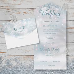 the wedding stationery is on display next to an envelope and snowflaked paper