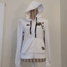 White Puff Sleeve Velour Hoodie With A Drawstring Hood & Pockets By Juicy Couture Size S Nwt ~ New - Does Have A Faint Dirty Mark On The Front - Needs To Be Washed Details: Full Zip Closure Front Pockets Goldtone Hardware J Zipper Pull Drawstring Hood Long Puff Sleeves Ribbed Cuffs Black & Gold Graphics I Love La Pit-Pit 18" Pit-Hem 14" Approx Machine Washable Msrp $128 Stock Image Of A Similar Item For Reference Of Fit Bundle This Item With Another To Save 30% On Your Entire Bundle ~ Or Just Ma Trendy White Hooded Jacket For Streetwear, Trendy White Outerwear With Drawstring Hood, White Cotton Sporty Hooded Jacket, Trendy White Hooded Jacket With Drawstring, Sporty White Hooded Jacket For Spring, White Cotton Hooded Jacket For Fall, White Hooded Jacket For Fall, White Hooded Jacket With Adjustable Hood For Spring, Trendy White Cotton Hooded Jacket