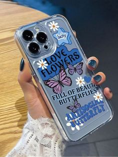 a person holding up a clear case with flowers and butterflies on the back of it