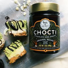 an assortment of desserts with chocolate sauce and whipped cream on the top, next to a jar of chocti