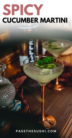 two glasses filled with drinks sitting on top of a wooden table