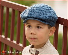 a young boy wearing a blue knitted hat