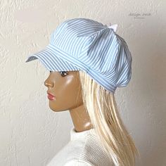 This fashionable cap for women is made of cotton fabric. A beautiful cap with a bow is a very fashionable item for your summer wardrobe. The visor of the cap is asymmetric, - an unusual shape. Beautiful pale blue color goes well with white. This cap is suitable for various occasions - walking along the city streets on a hot sunny day, a beach holiday, etc. Cap with cotton lining. Size 55-57 cm. Cotton Flat Cap For Summer, Blue Cotton Sun Hat One Size Fits Most, White Flat Cap For The Beach, White Flat Cap For Beach, Blue Cotton Summer Hat, Summer Cotton Baseball Cap With Short Brim, Blue Cotton Flat Cap, Cotton Baseball Cap With Short Brim For Spring, Short Brim Cotton Baseball Cap For Spring