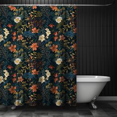 a bath tub sitting next to a shower curtain with flowers on it in a bathroom