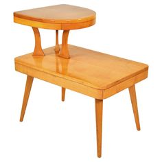 a small wooden table with two legs on it