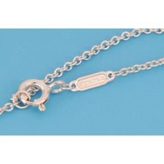 Brand: Tiffany & Co.  Hallmark: Tiffany & Co. Ag925   Material:  sterling silver and enamel  Measurements: adjustable chain: 28 - 30" long x 0.10" thick      Pendant: 1.60" long x 90" wide x 0.11" high  Weight:  17.5 grams    This long elegant authentic necklace is by Tiffany & Co. from Please Return to Tiffany & Co. Collection. It is crafted from sterling silver with a fine polished finish featuring a flat long oval shape pendant with Tiffany's green enamel splashed on the lower end of the pend White Gold Oval Jewelry With Cable Chain, White Gold Oval Cable Chain Jewelry, Oval White Gold Jewelry With Cable Chain, Silver Oval Cable Chain Jewelry, Silver Oval Cable Chain Necklace, Silver Oval Pendant Necklace With Cable Chain, Oval Silver Jewelry With Cable Chain, Silver Necklace With Oval Pendant And Cable Chain, Silver Oval Necklace With Cable Chain