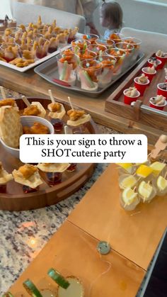 there are many snacks on the table and one has a sign that says, this is your sign to throw a shot - celerie party