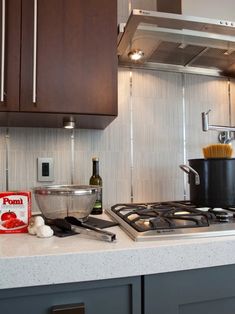 a stove top oven sitting inside of a kitchen next to a pot filled with food