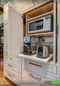 a kitchen with white cabinets and stainless steel appliances on the counter top in front of an open door