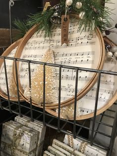 a table topped with lots of white and green christmas decorations on top of wooden trays