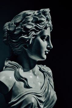 black and white photo of a statue of a woman's head with wavy hair