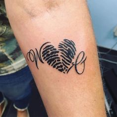 a heart shaped finger tattoo with scissors on the side of the arm and an arrow in the shape of a heart