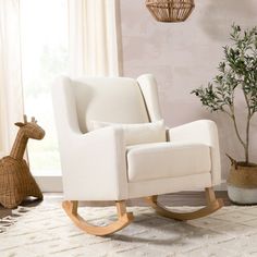 a rocking chair with a giraffe figurine next to it in front of a window